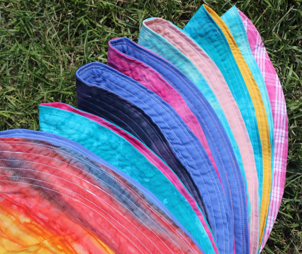 rainbow array of handmade reversible bucket hats
